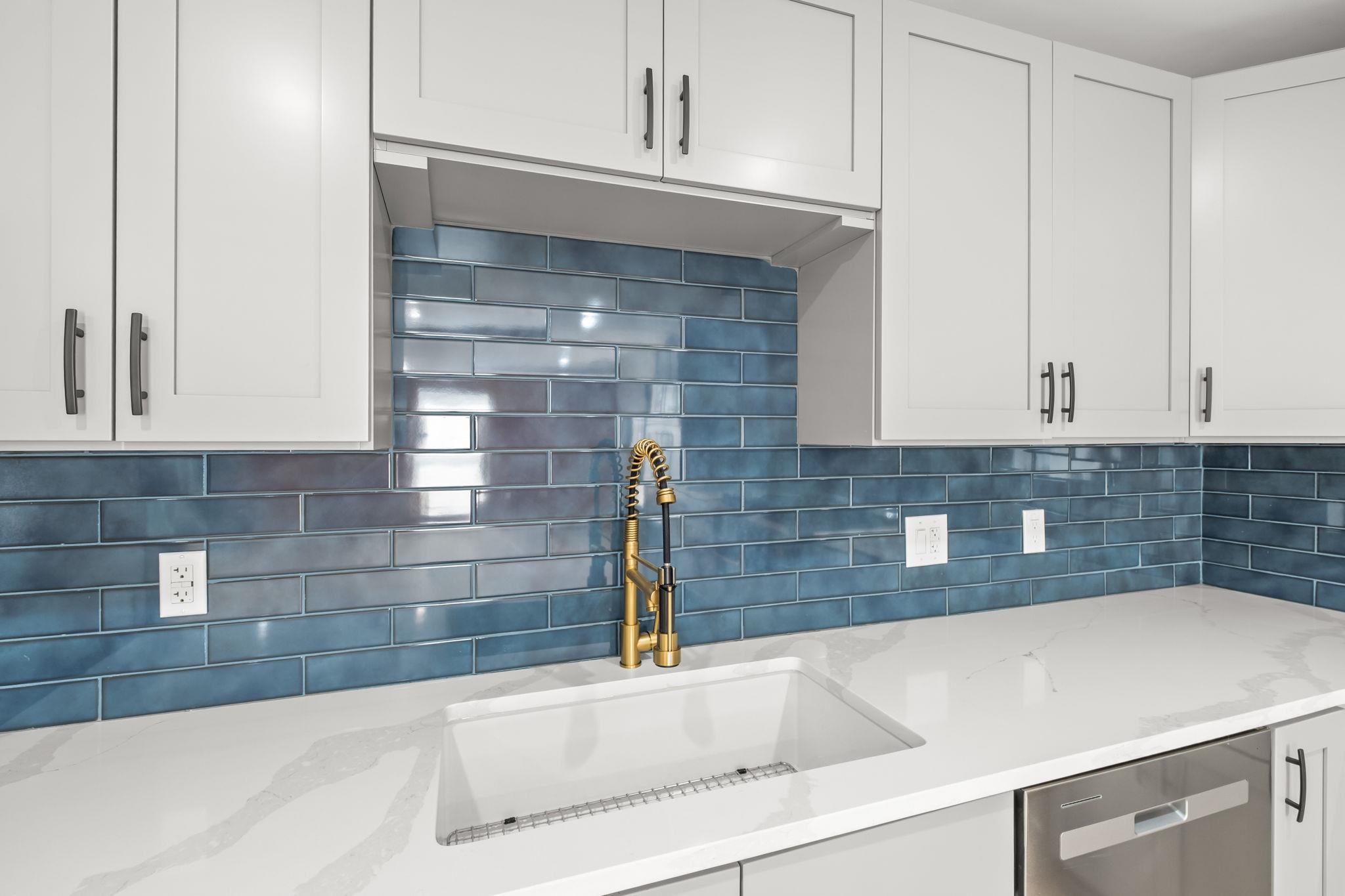 6224 Benjestown Road Memphis, TN 38127 - Photo 13 of 38 Kitchen featuring white cabinets, light stone counters, decorative backsplash, and stainless steel dishwasher