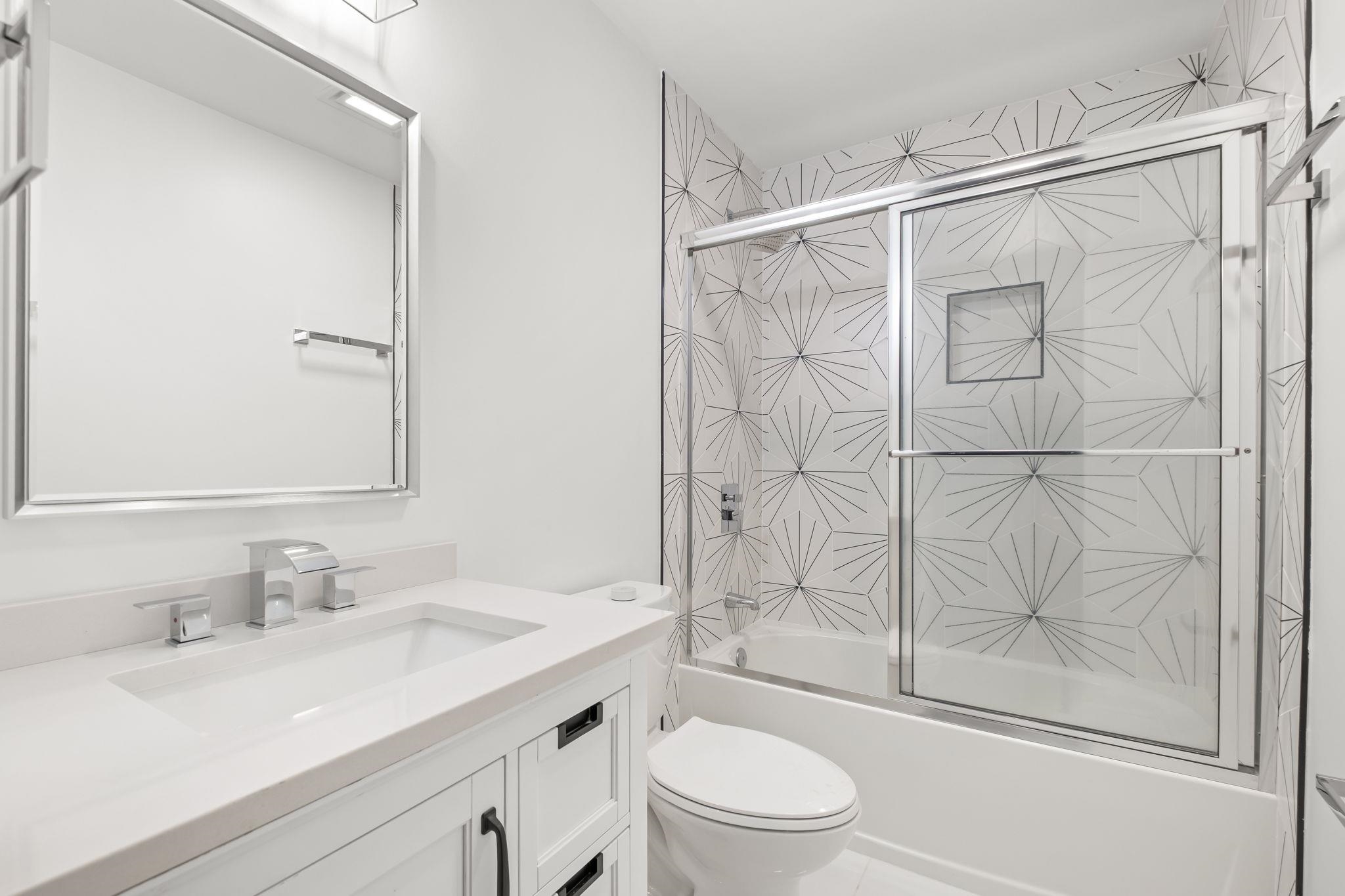 6224 Benjestown Road Memphis, TN 38127 - Photo 26 of 38 a bathroom with a granite countertop sink toilet and shower