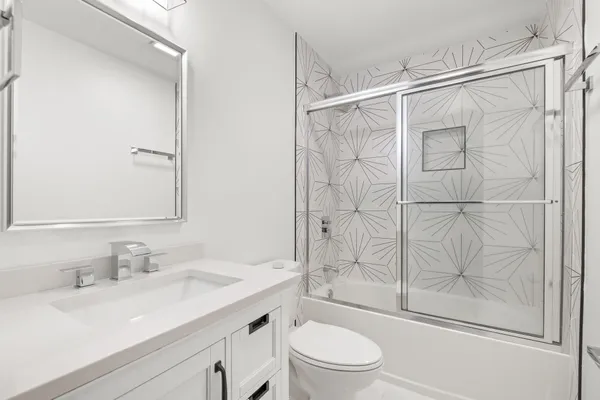 a bathroom with a tub a sink and a shower