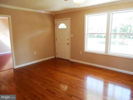 117 Michelle Drive Ranson, WV 25438 - Photo 7 of 24 an empty room with wooden floor and windows