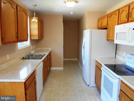 117 Michelle Drive Ranson, WV 25438 - Photo 9 of 24 a kitchen with a sink stove and refrigerator