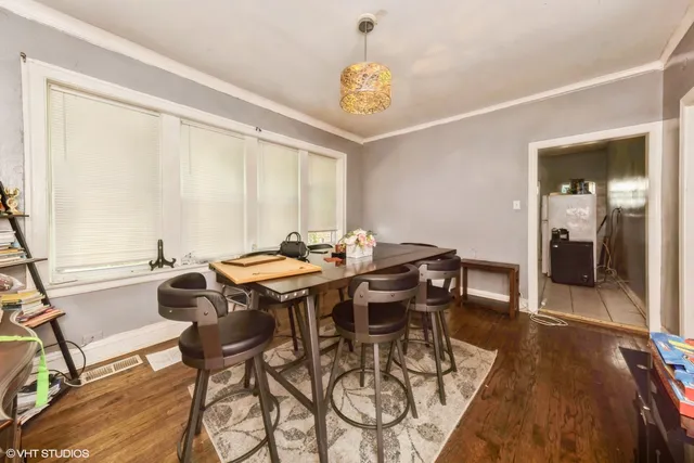 a view of a dining room with furniture and wooden floor