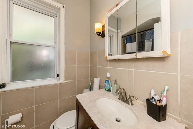 a bathroom with a sink toilet and mirror