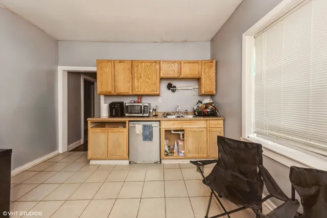 a kitchen with a stove a sink and a microwave