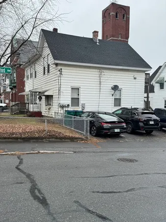 a couple of cars parked in front of a house