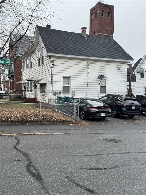 a couple of cars parked in front of a house
