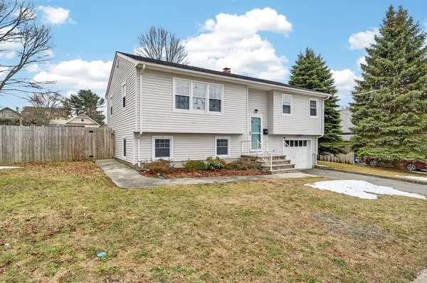 a view of a house with backyard and sitting area