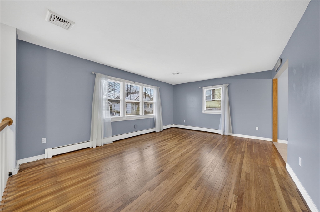 25 Morton Street Fairhaven, MA 02719 - Photo 11 of 34 a view of an empty room with wooden floor and windows