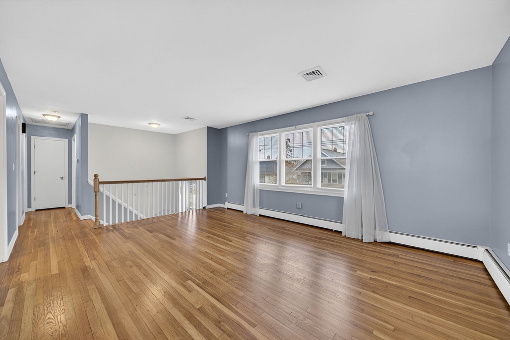 25 Morton Street Fairhaven, MA 02719 - Photo 12 of 34 a view of an empty room with wooden floor and a window
