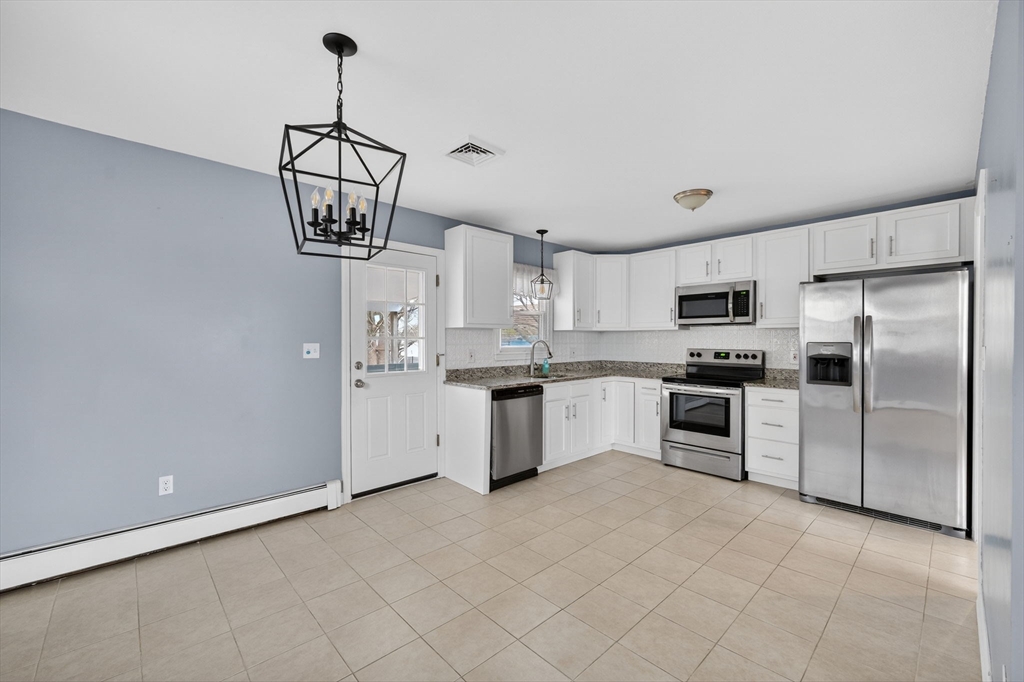 25 Morton Street Fairhaven, MA 02719 - Photo 14 of 34 a kitchen with stainless steel appliances a refrigerator sink and white cabinets
