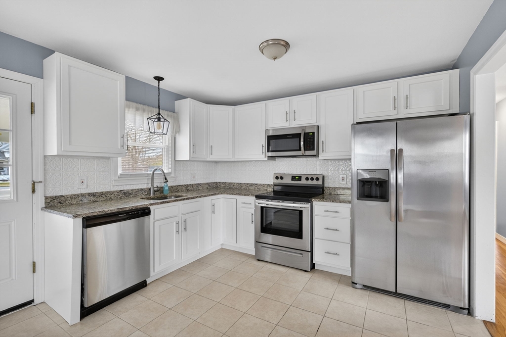 25 Morton Street Fairhaven, MA 02719 - Photo 16 of 34 a kitchen with granite countertop white cabinets and stainless steel appliances