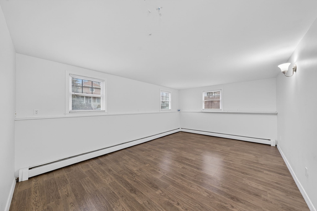 25 Morton Street Fairhaven, MA 02719 - Photo 30 of 34 an empty room with wooden floor and windows