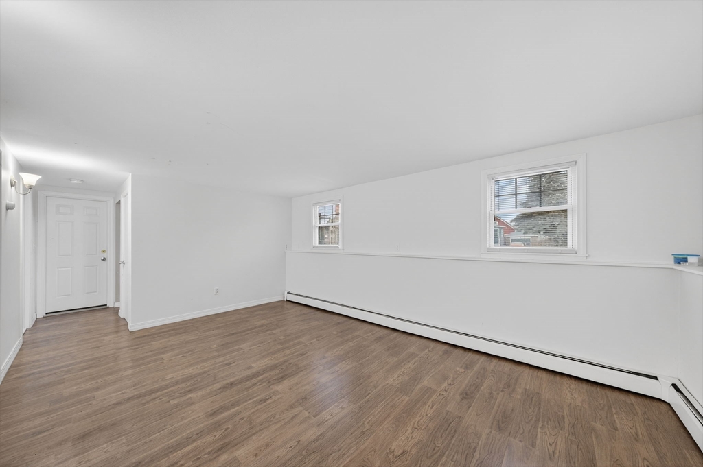 25 Morton Street Fairhaven, MA 02719 - Photo 31 of 34 an empty room with wooden floor and windows