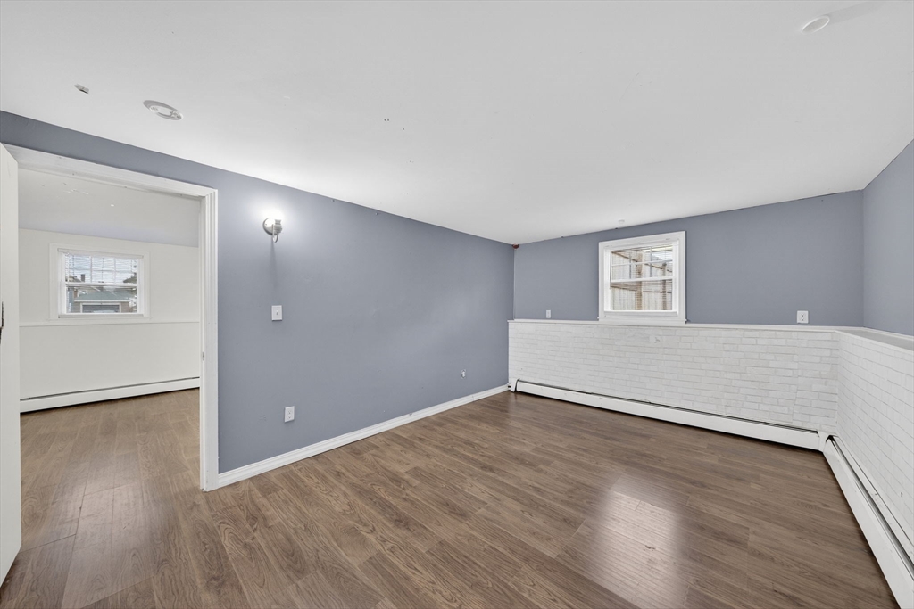 25 Morton Street Fairhaven, MA 02719 - Photo 33 of 34 an empty room with wooden floor and windows