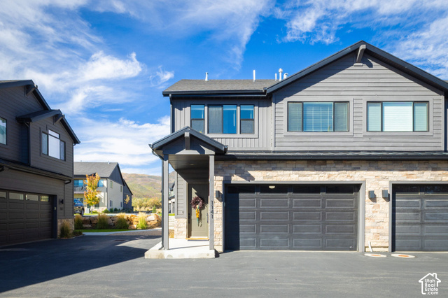 1141 520 West Midway, UT 84049 - Photo 1 of 40 Contemporary exterior design featuring horizontal siding and stone accents, covered entry, and attached garages