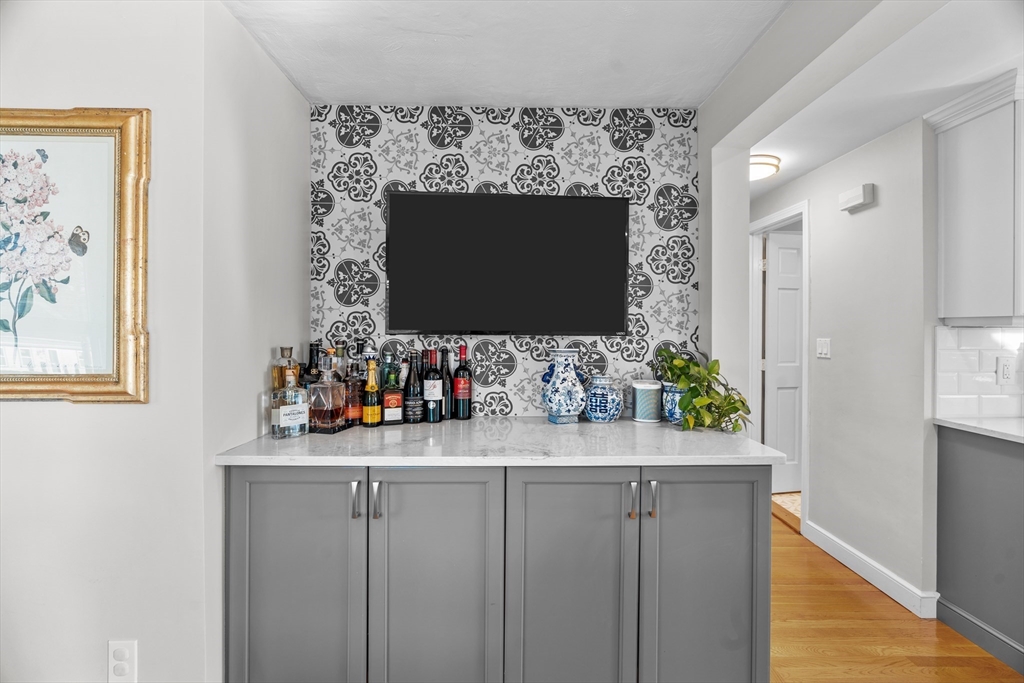 21 Oakvale Road Framingham, MA 01701 - Photo 11 of 42 a room with a mirror and a flat screen tv