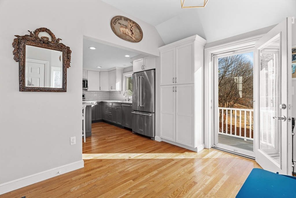 21 Oakvale Road Framingham, MA 01701 - Photo 4 of 42 a view of a kitchen with wooden floor and a refrigerator