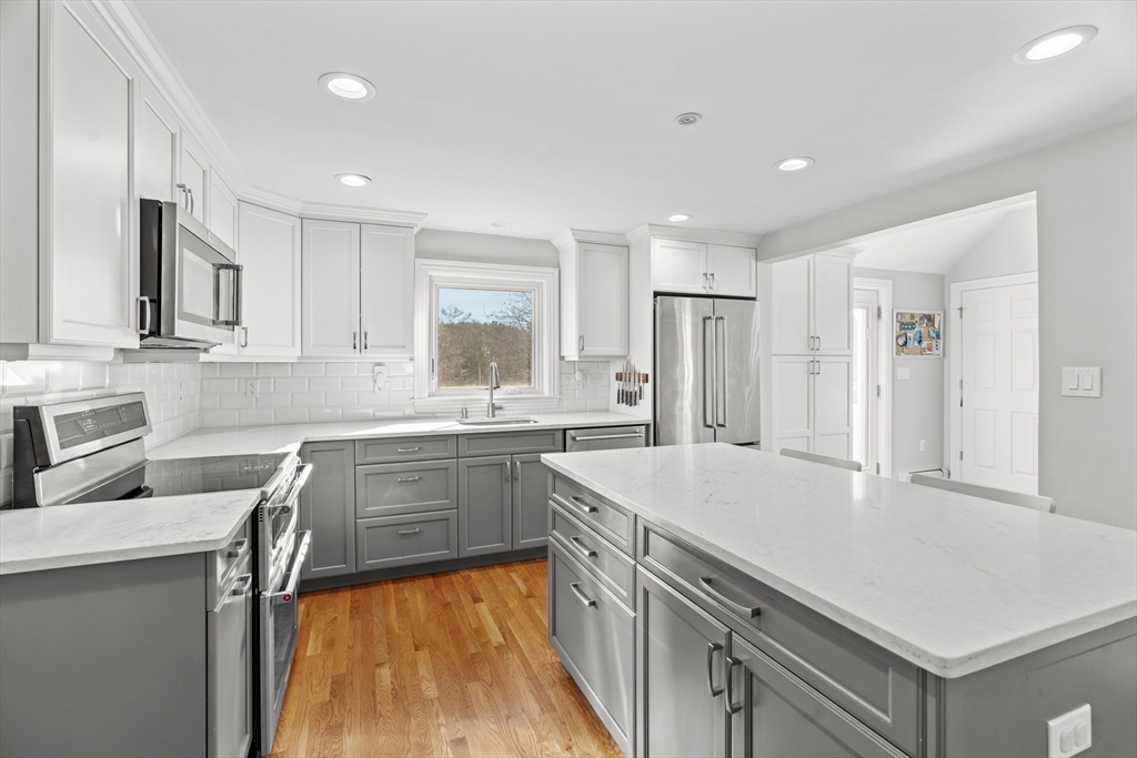 21 Oakvale Road Framingham, MA 01701 - Photo 9 of 42 a kitchen with a sink stove and refrigerator