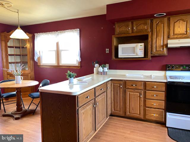 1026 Green Valley Road New Windsor, MD 21776 - Photo 11 of 57 a kitchen with a sink stove and wooden floor