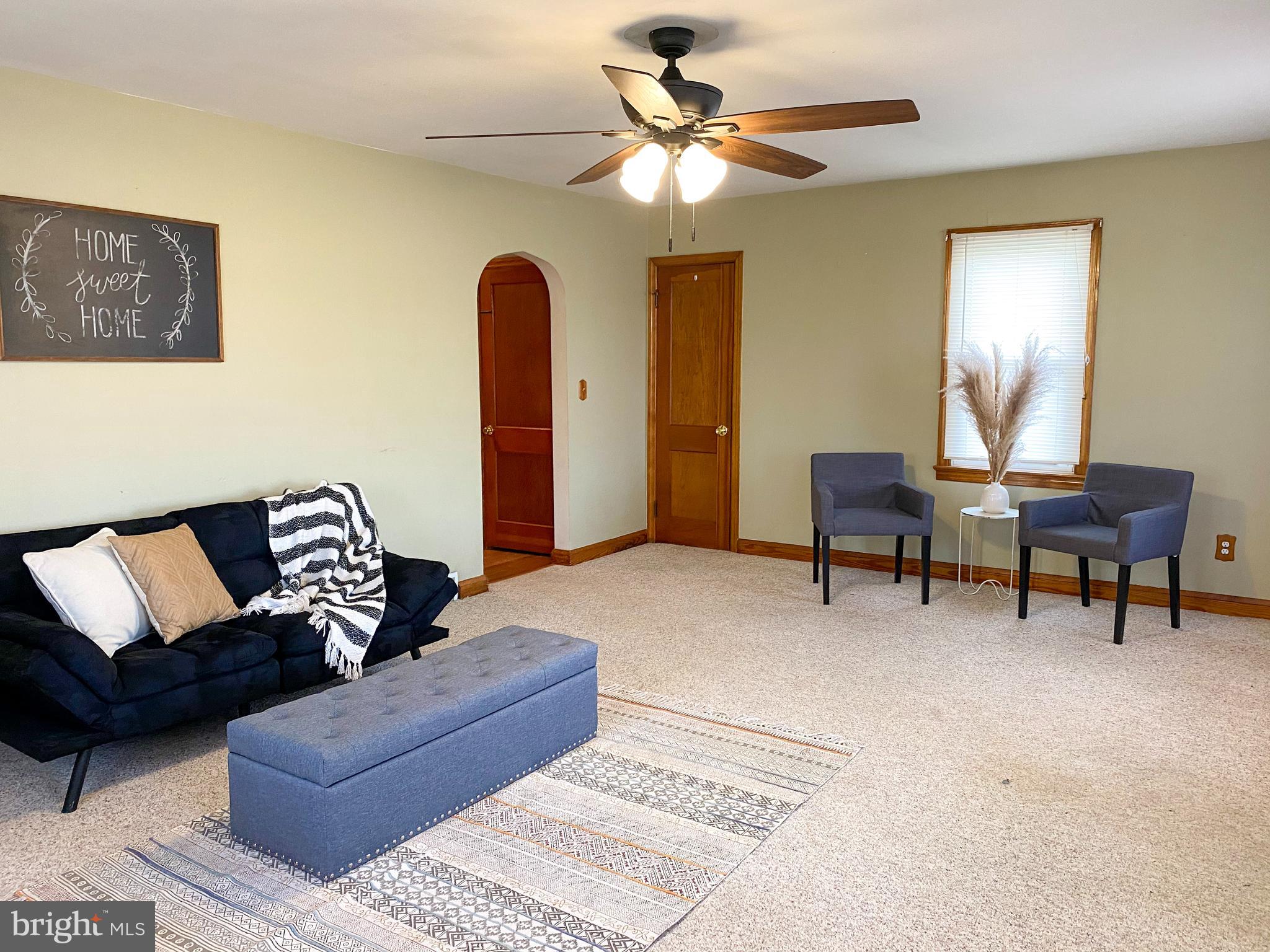 1026 Green Valley Road New Windsor, MD 21776 - Photo 2 of 57 a living room with furniture and a chandelier