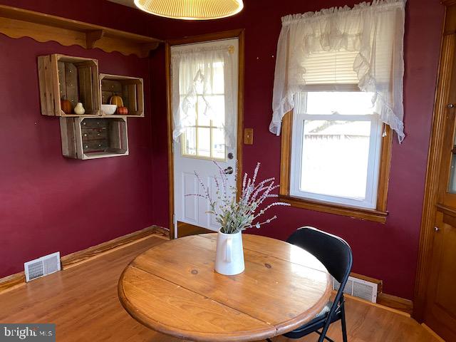 1026 Green Valley Road New Windsor, MD 21776 - Photo 29 of 57 a view of a dining room with furniture window and wooden floor