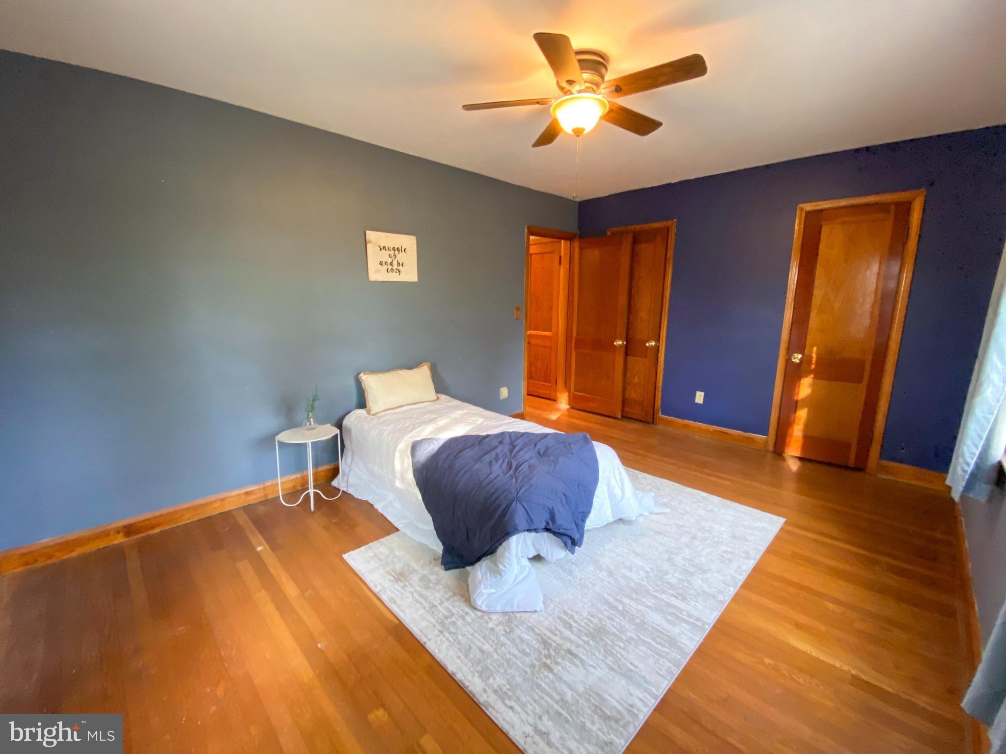 1026 Green Valley Road New Windsor, MD 21776 - Photo 36 of 57 a bedroom with a bed and wooden floor