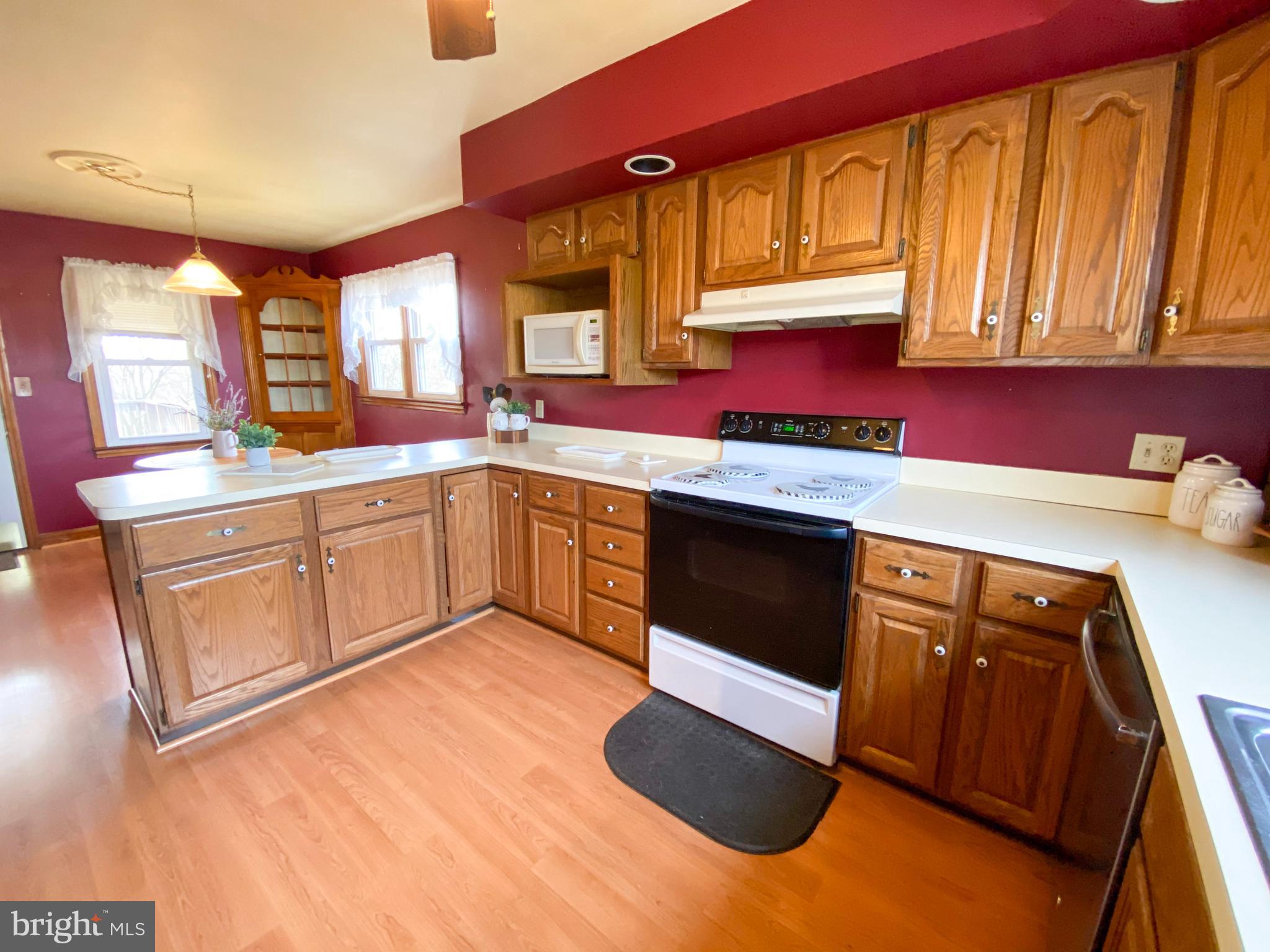 1026 Green Valley Road New Windsor, MD 21776 - Photo 44 of 57 a kitchen with stainless steel appliances granite countertop a stove a sink and a microwave