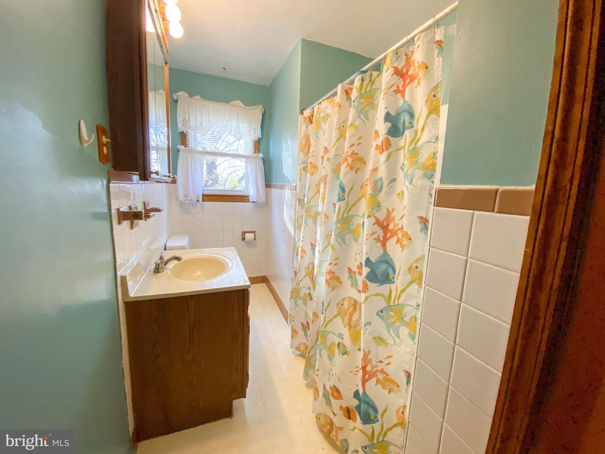 1026 Green Valley Road New Windsor, MD 21776 - Photo 45 of 57 a bathroom with a sink toilet and shower