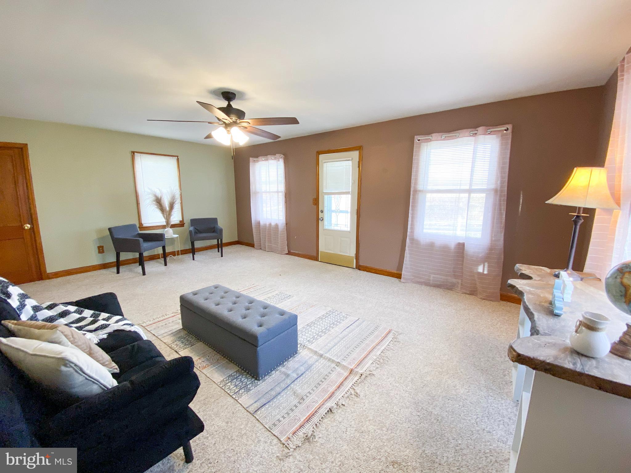 1026 Green Valley Road New Windsor, MD 21776 - Photo 5 of 57 a living room with furniture and a chandelier