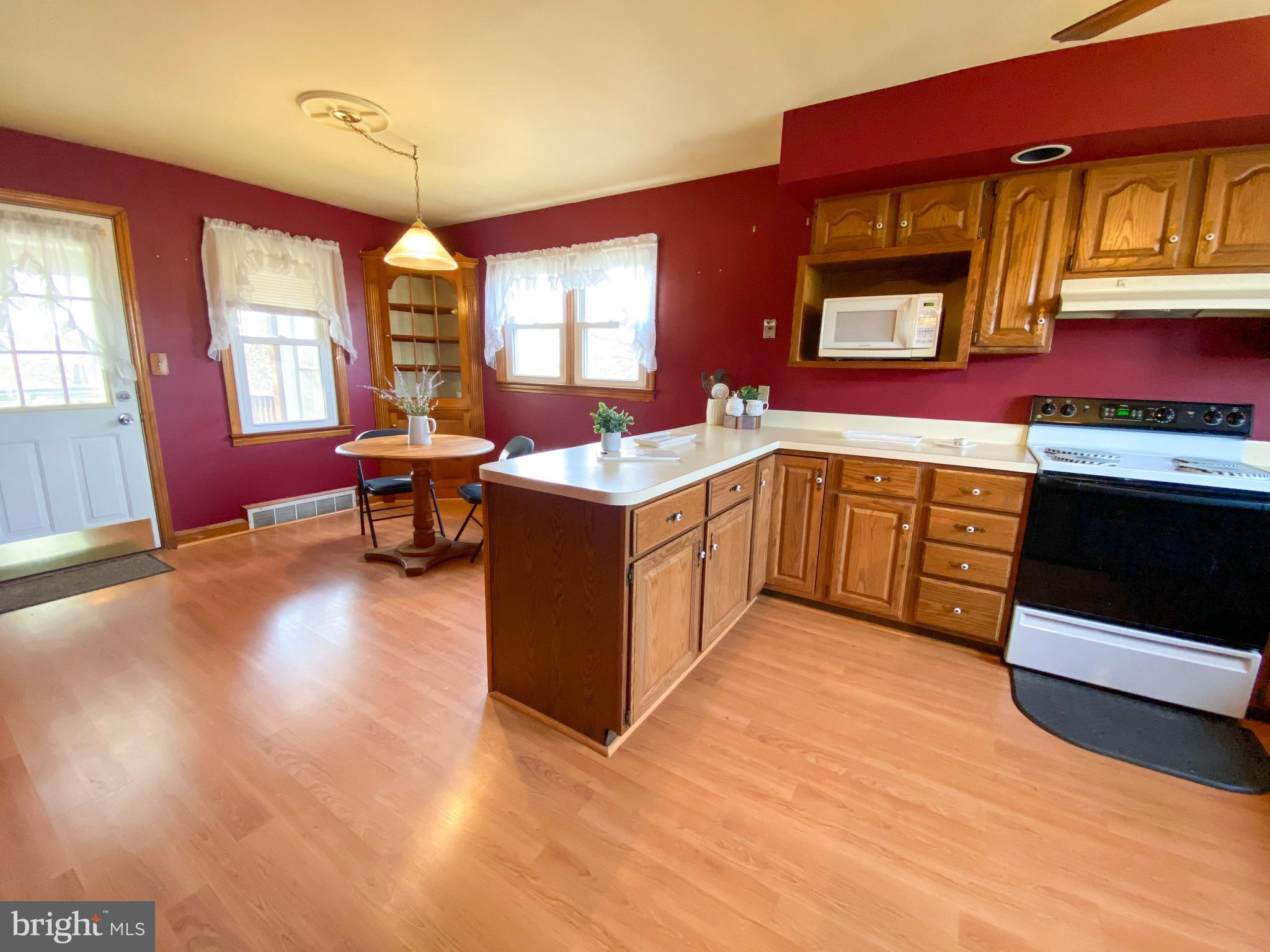 1026 Green Valley Road New Windsor, MD 21776 - Photo 9 of 57 a kitchen with stainless steel appliances granite countertop a stove top oven a sink dishwasher and cabinets with wooden floor