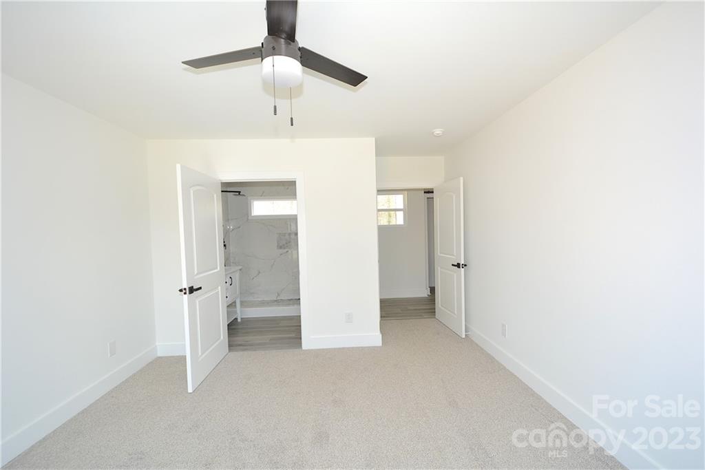 1511 Farm Road Shelby, NC 28152 - Photo 13 of 36 a view of a room with a chandelier fan and wooden floor