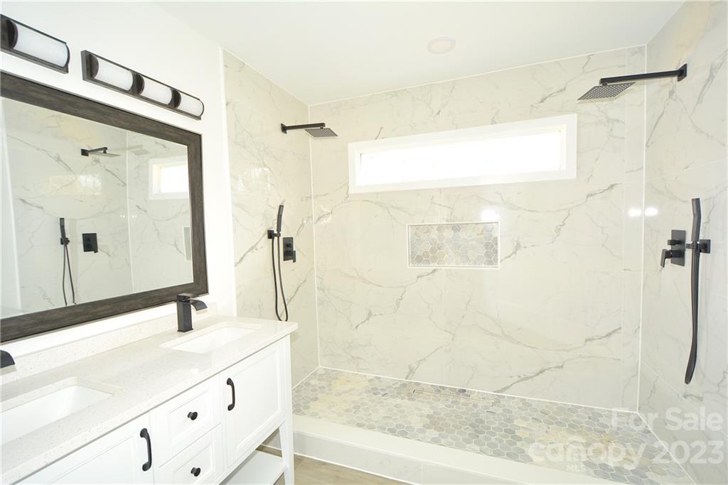 1511 Farm Road Shelby, NC 28152 - Photo 14 of 36 a bathroom with a granite countertop shower sink and mirror