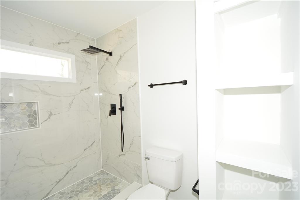 1511 Farm Road Shelby, NC 28152 - Photo 16 of 36 a bathroom with a toilet and a shower