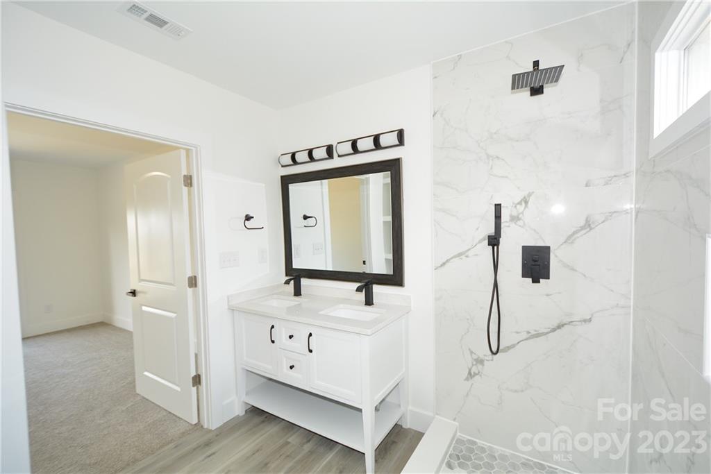 1511 Farm Road Shelby, NC 28152 - Photo 17 of 36 a bathroom with a sink a mirror and shower