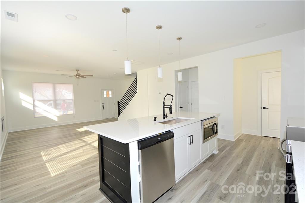 1511 Farm Road Shelby, NC 28152 - Photo 8 of 36 a kitchen with a sink stove and wooden floor