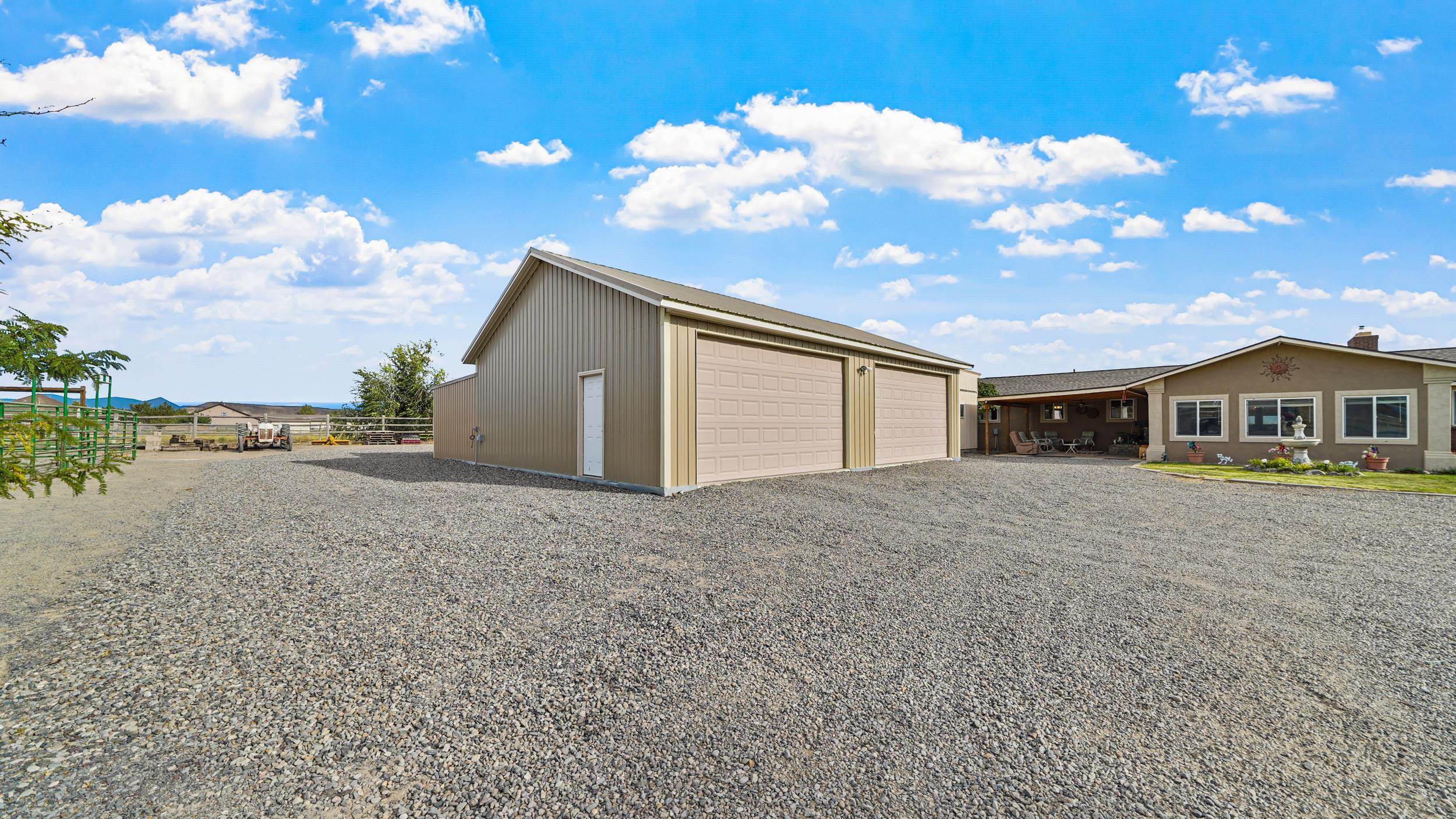 20786 Iris Road Austin, CO 81410 - Photo 32 of 38 a front view of a house with a yard and garage