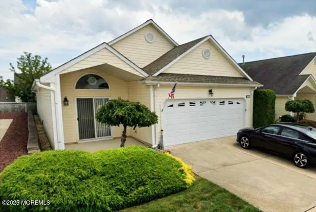 a front view of a house with a garden