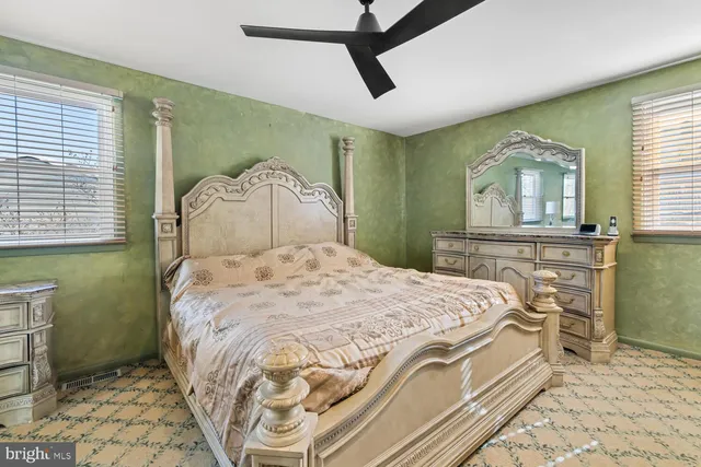 a spacious bedroom with a bed and a chandelier