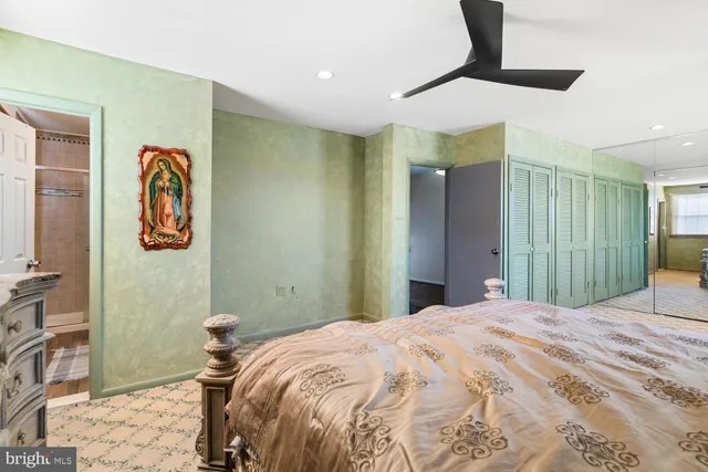 a bedroom with a bed and a painting on the wall