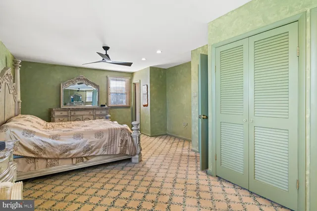 a bedroom with a bed and a large window