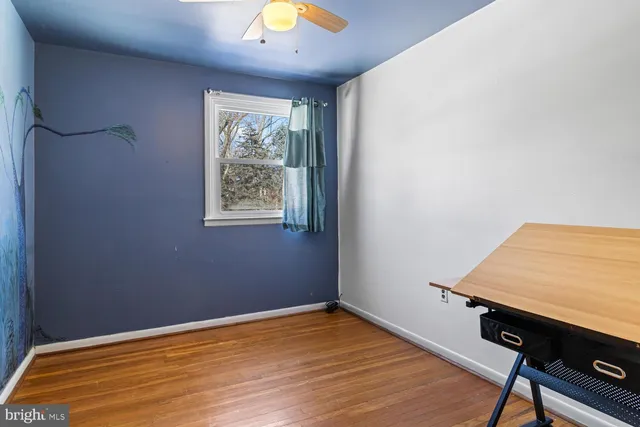 a view of room with window and wooden floor