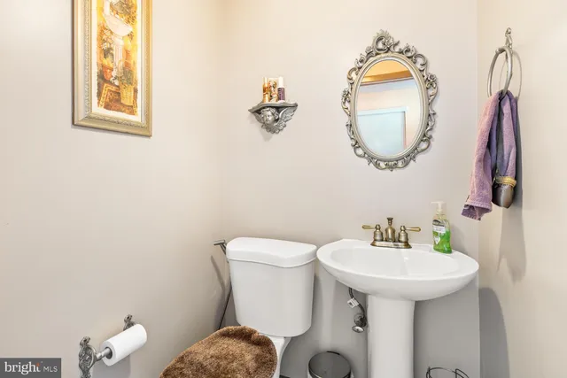 a bathroom with a sink mirror and toilet