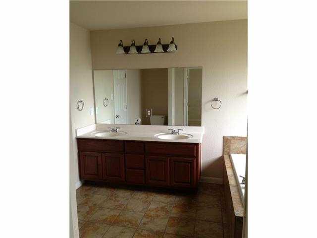 230 Kiras Court Austin, TX 78737 - Photo 5 of 10 a bathroom with a sink and a mirror