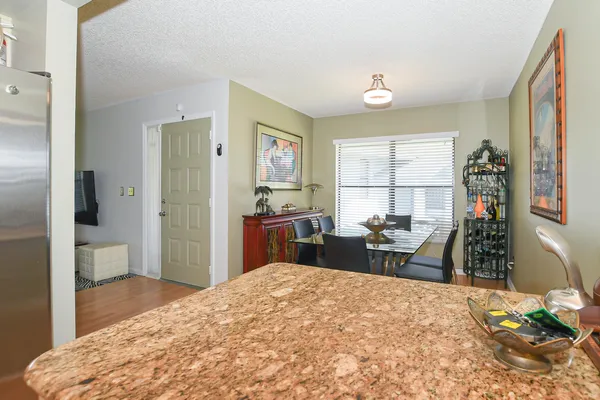 a bathroom with a granite countertop sink a toilet and a mirror