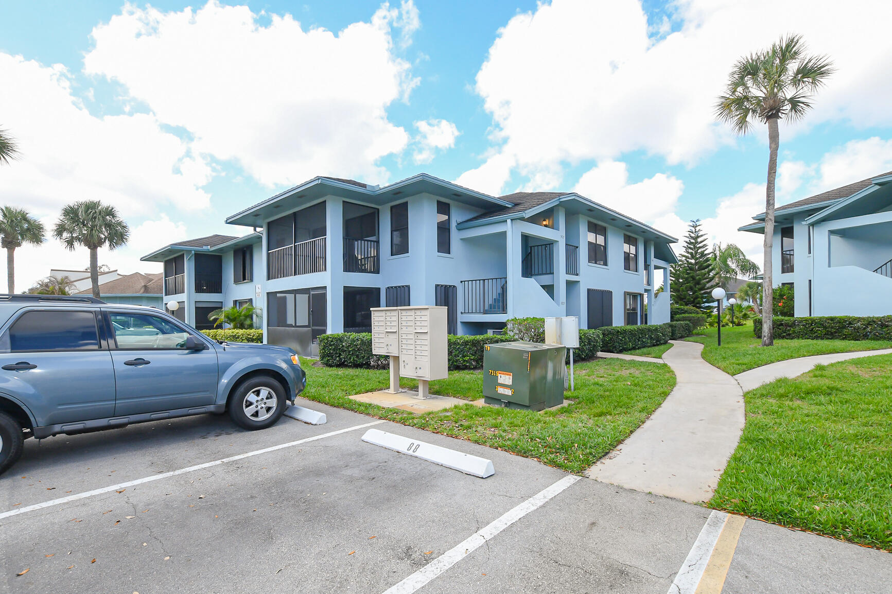 950 South Kanner Highway, Unit 905 Stuart, FL 34994 - Photo 2 of 34 a front view of a house with a yard