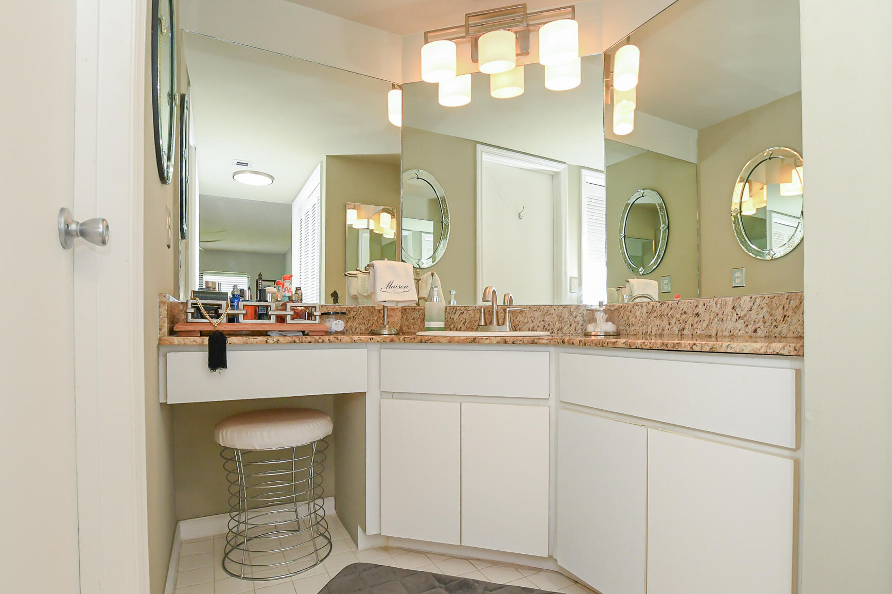950 South Kanner Highway, Unit 905 Stuart, FL 34994 - Photo 21 of 34 a bathroom with a granite countertop sink a toilet and a mirror