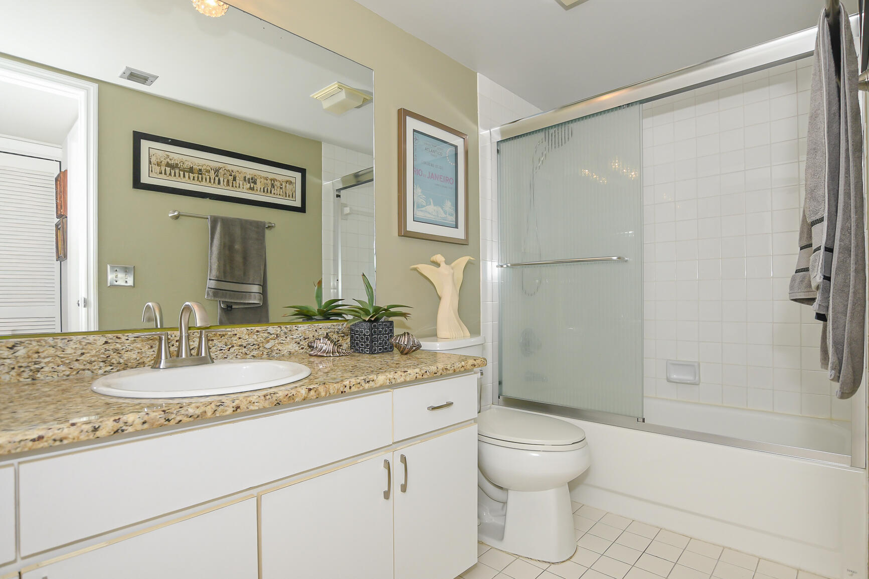 950 South Kanner Highway, Unit 905 Stuart, FL 34994 - Photo 24 of 34 a bathroom with a granite countertop sink toilet and shower