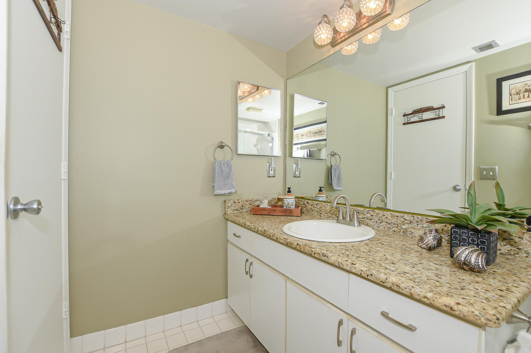 950 South Kanner Highway, Unit 905 Stuart, FL 34994 - Photo 25 of 34 a bathroom with a granite countertop sink and a mirror