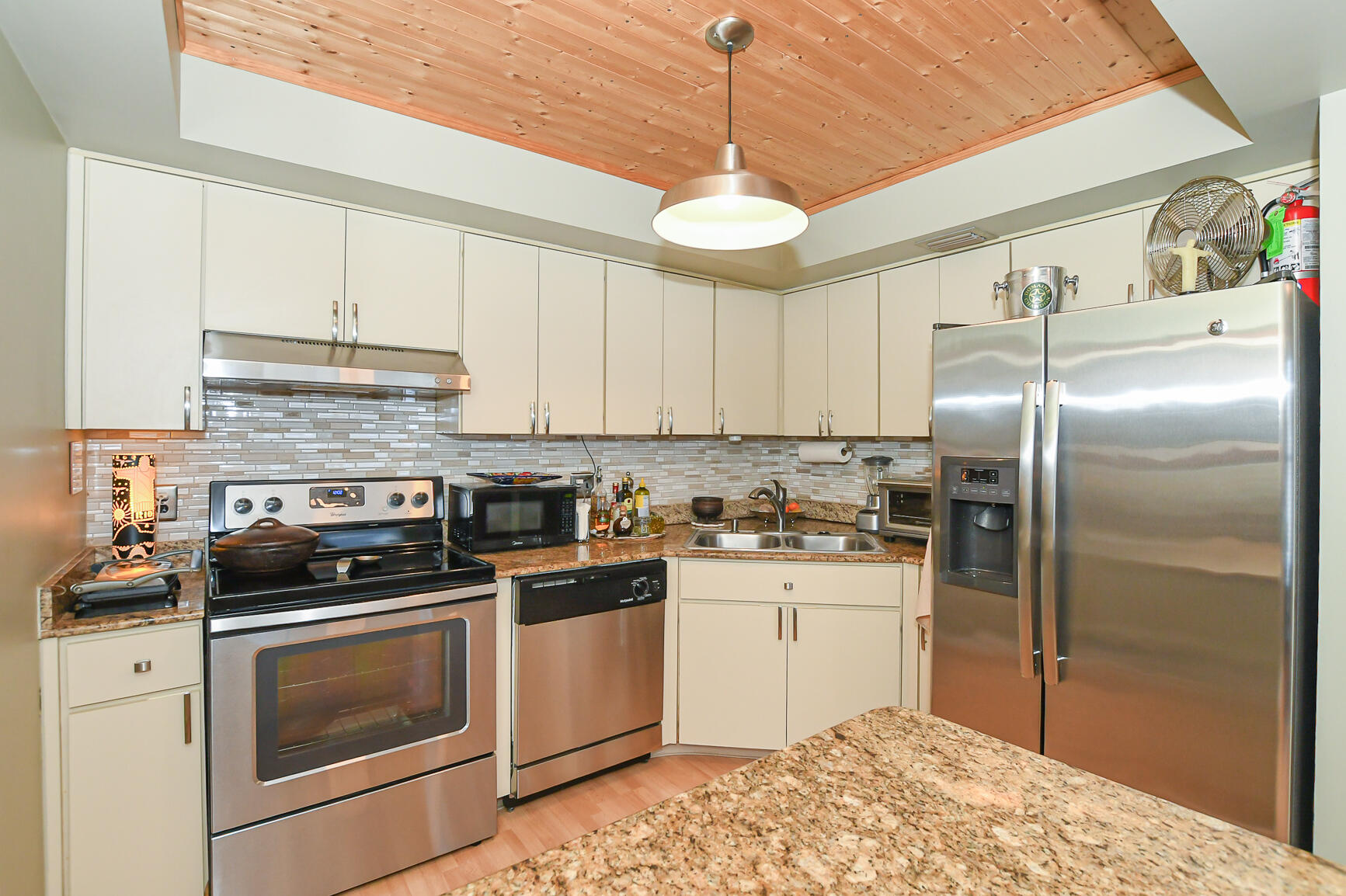 950 South Kanner Highway, Unit 905 Stuart, FL 34994 - Photo 7 of 34 a kitchen with stainless steel appliances granite countertop a stove a refrigerator and a sink with cabinets