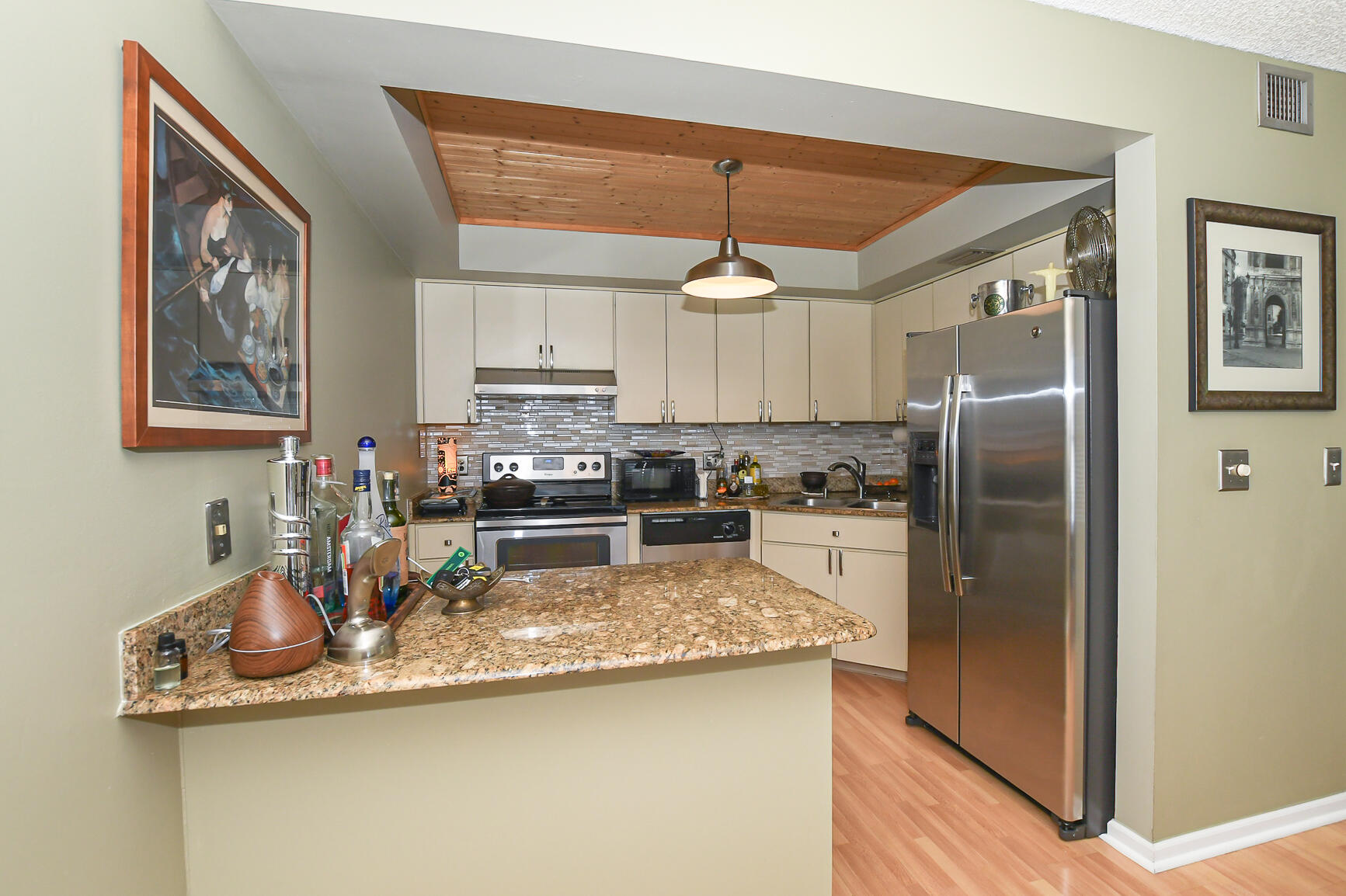 950 South Kanner Highway, Unit 905 Stuart, FL 34994 - Photo 8 of 34 a kitchen with stainless steel appliances granite countertop a refrigerator a stove and a sink with cabinets